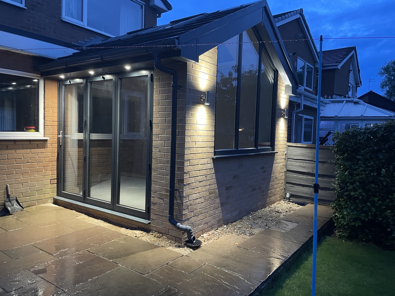 The same extension with its exterior lighting at dusk